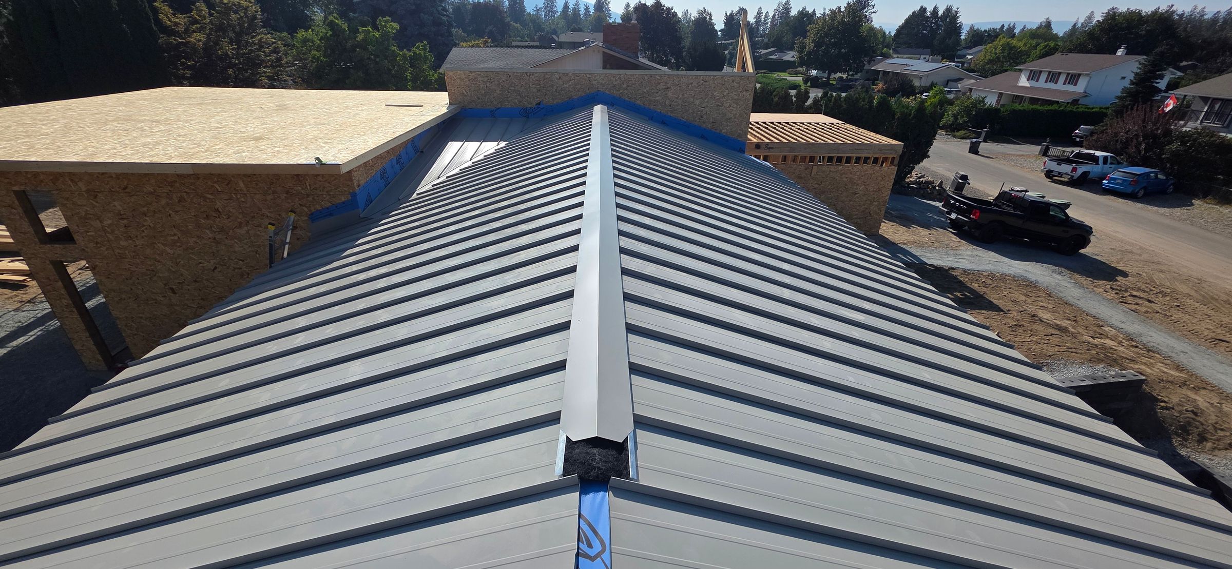 Snap lock metal roof with vented ridge and no exposed fasteners on residential home in Kelowna BC