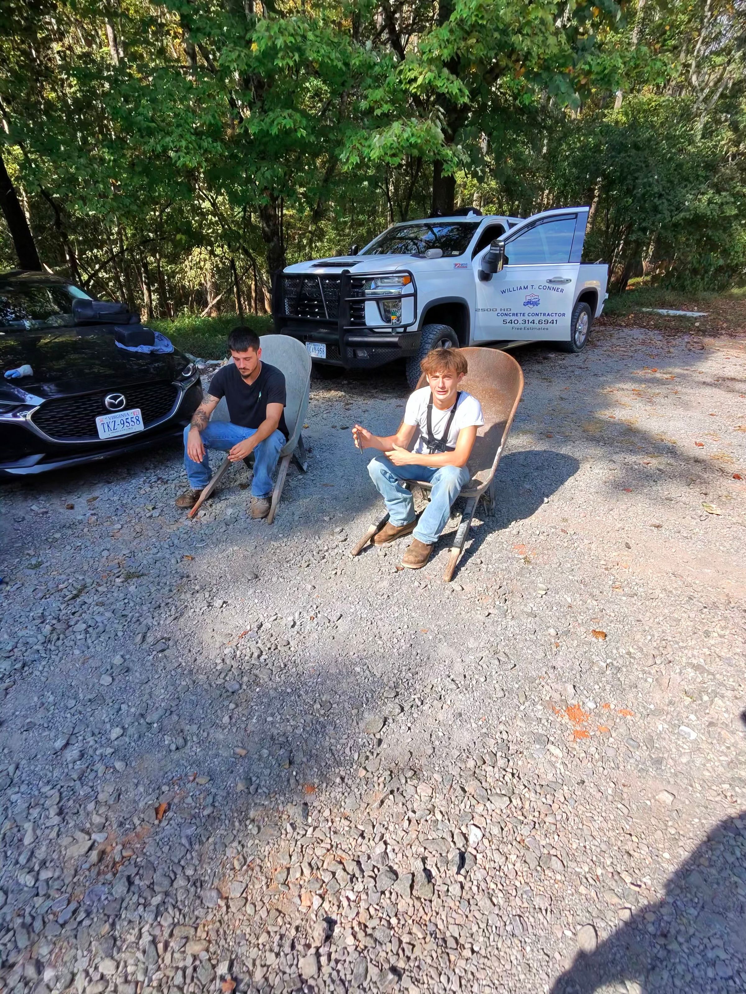 Guys Using Wheelbarrows as Chairs