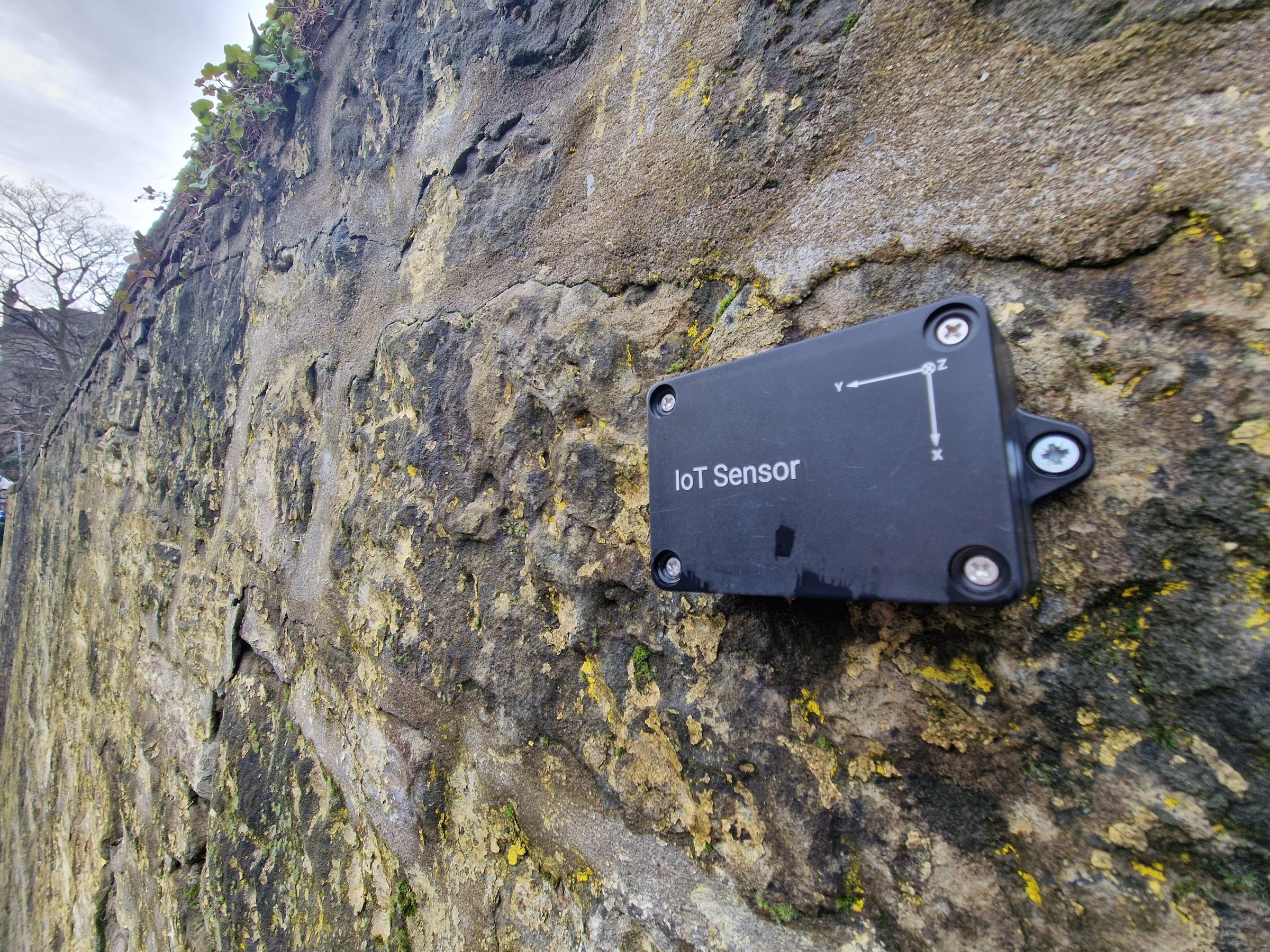IOT Tilt Sensor attached to a stone wall