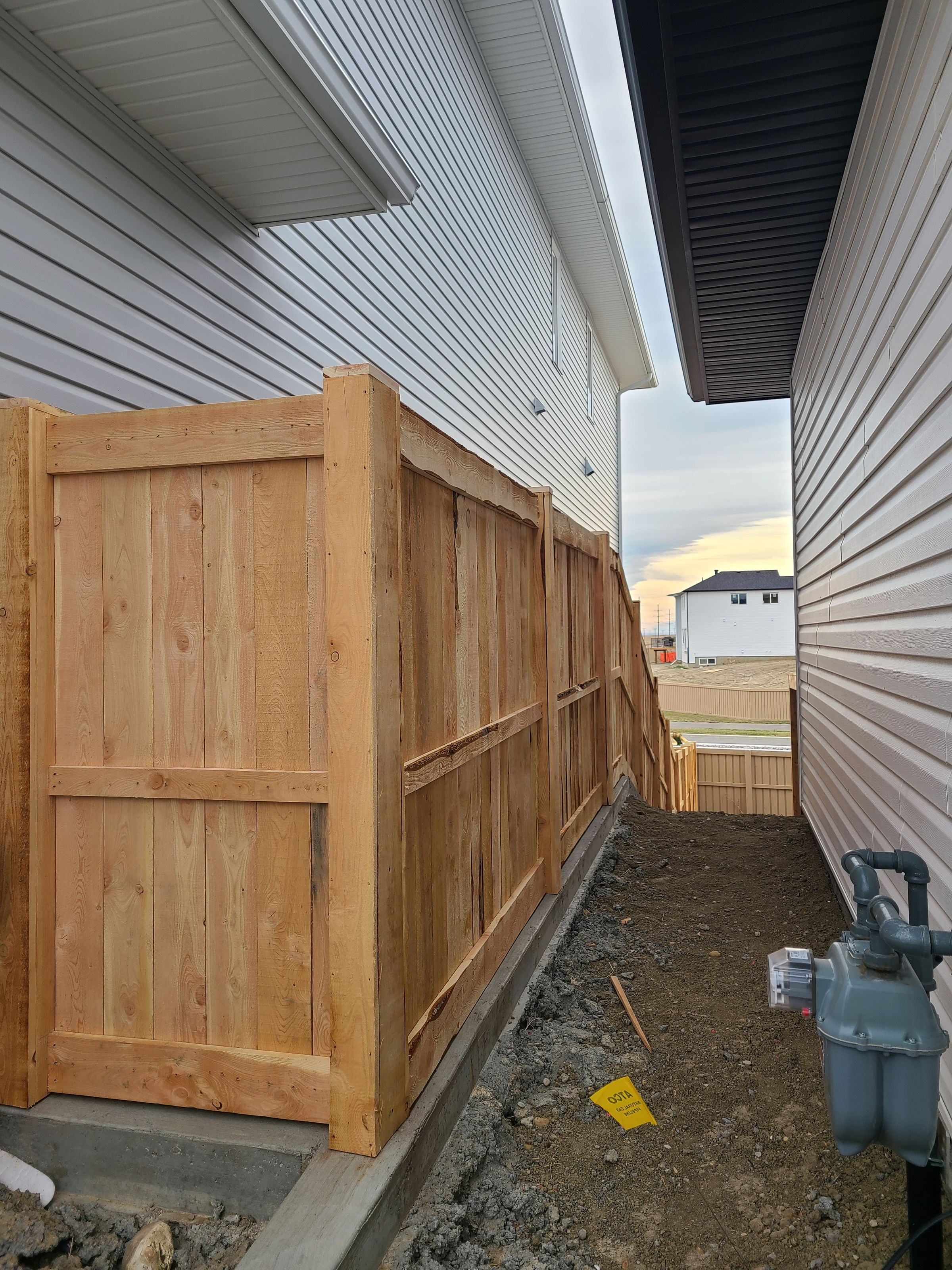 Metal fence posts boxed in with fur and fur fence boards