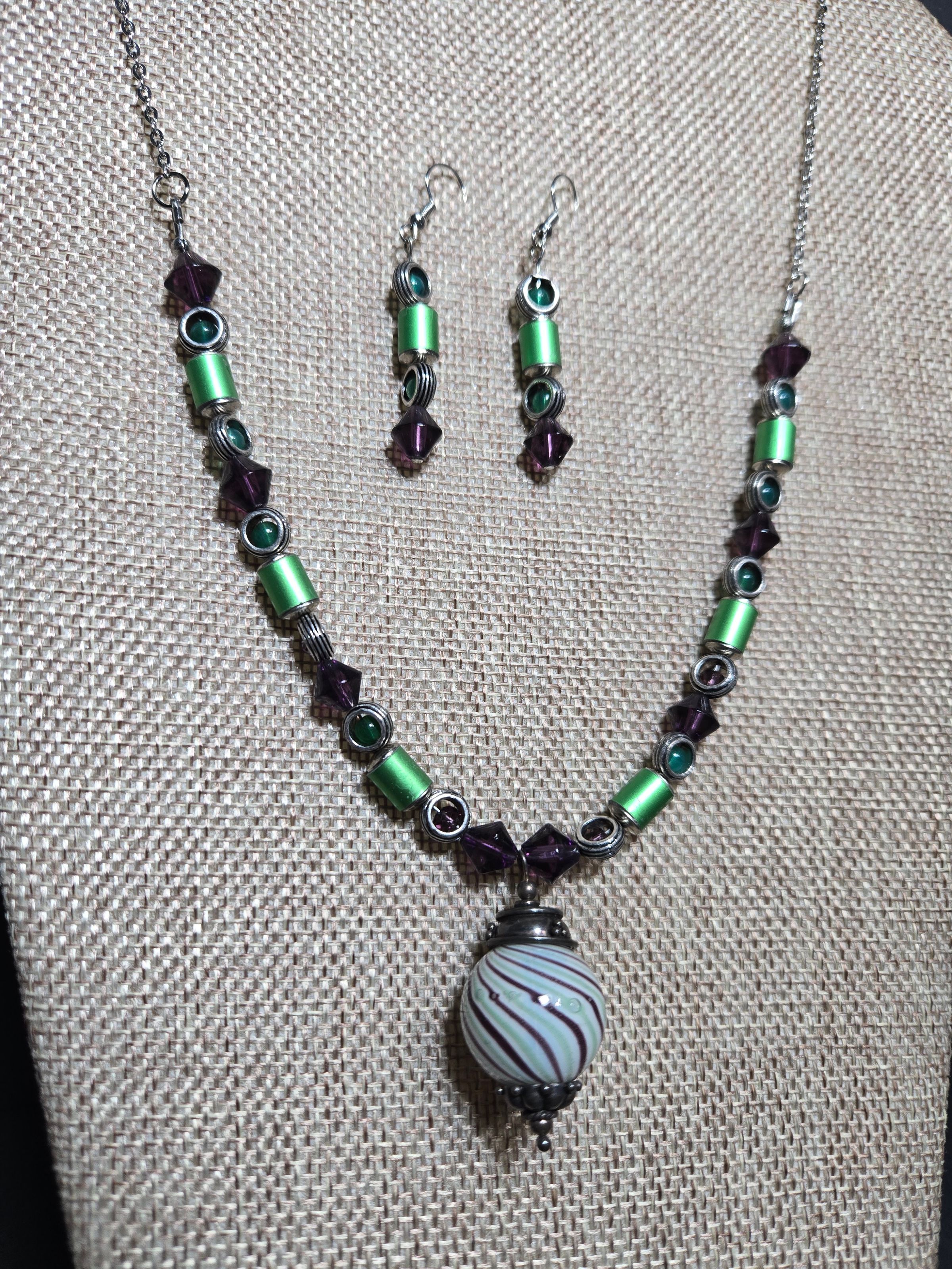 Details of blown glass pendant and aluminum knitting needle beads