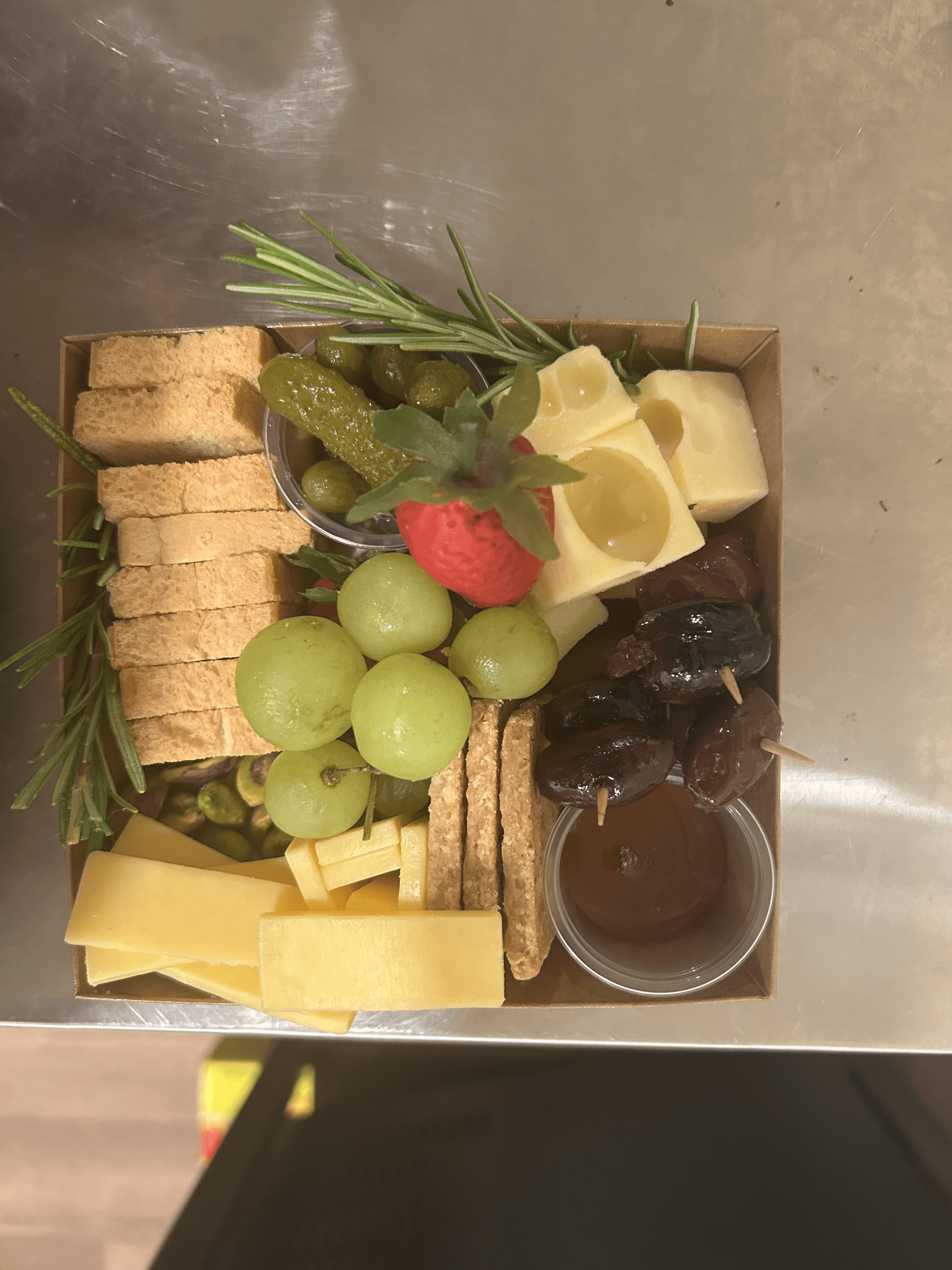 A classic European-inspired board with Swiss cheese, cured meats, cornichons, whole grain mustard, and fresh baguette slices.