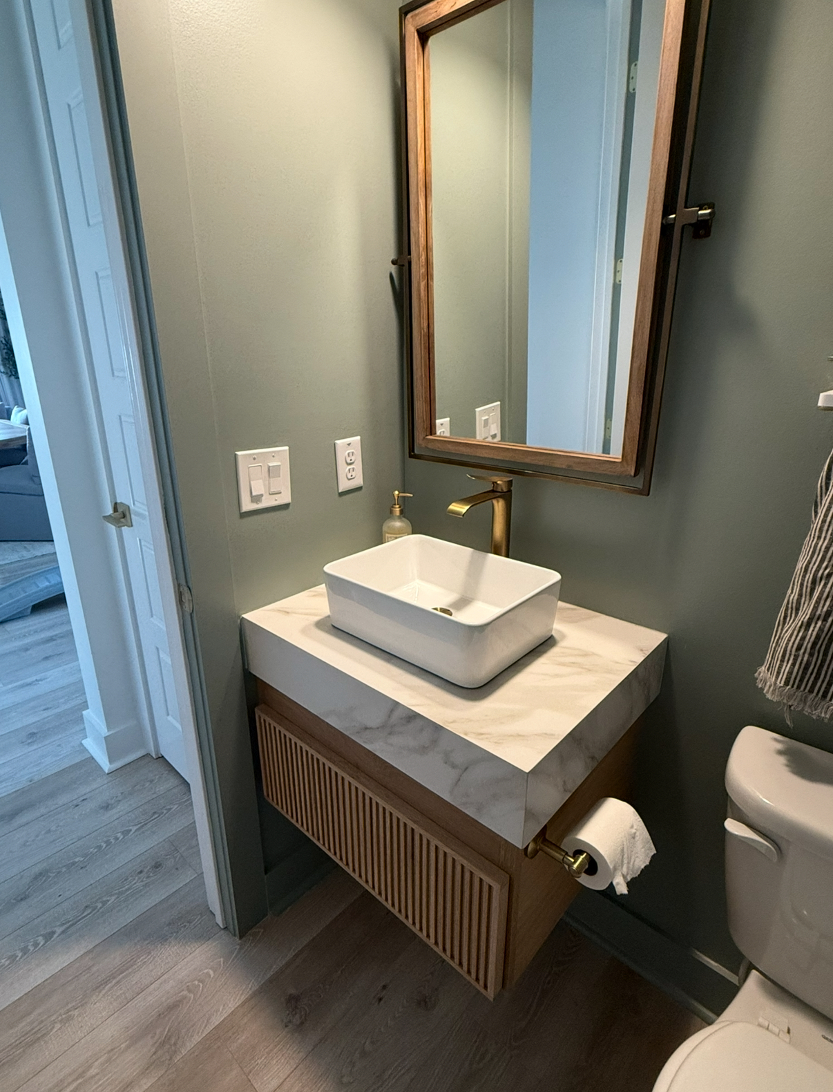 Neat little white oak floating vanity with reeded drawer front 