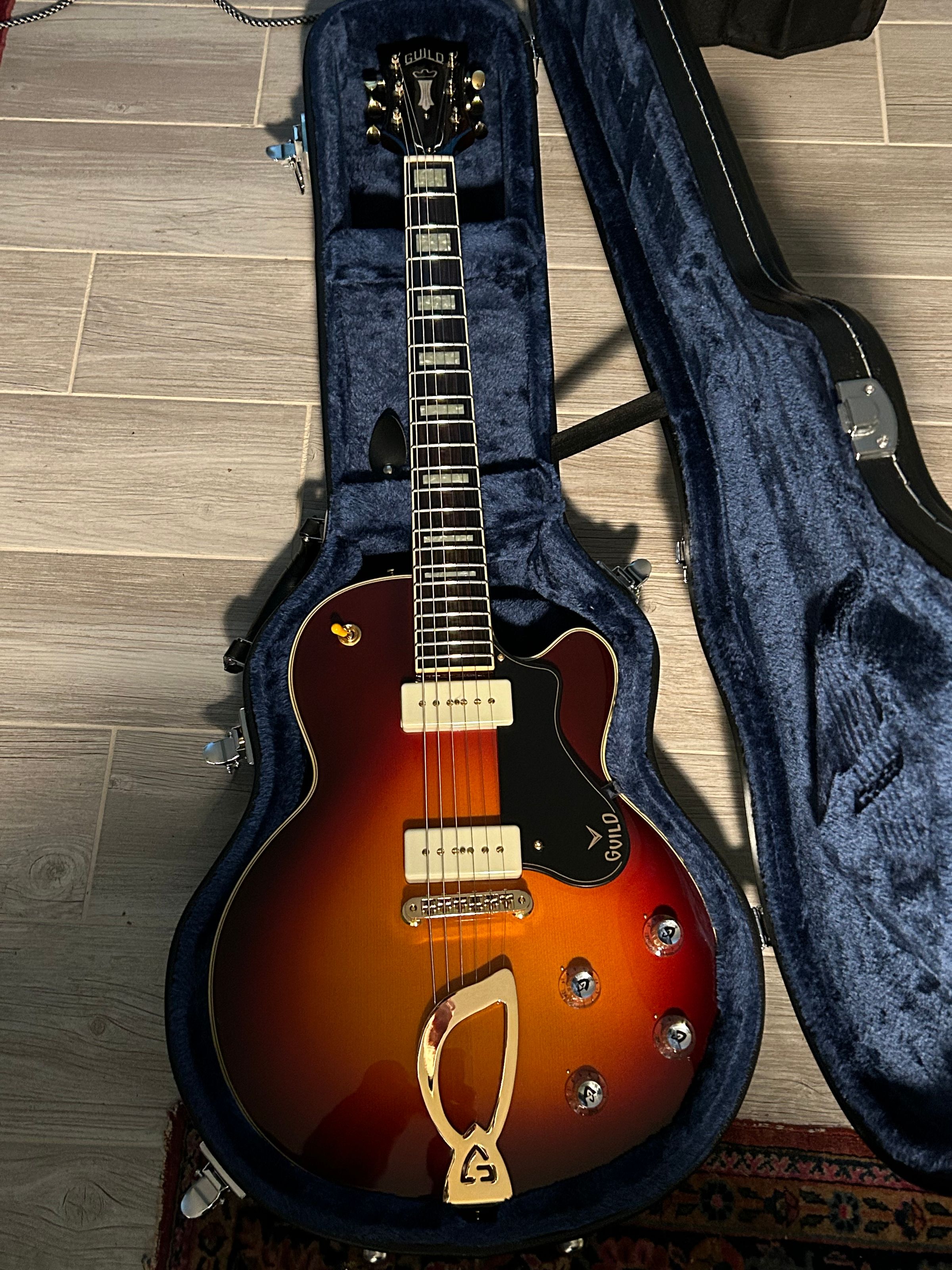 Beautiful Guild shipped to the customer. Set up completed, and note no F holes. 