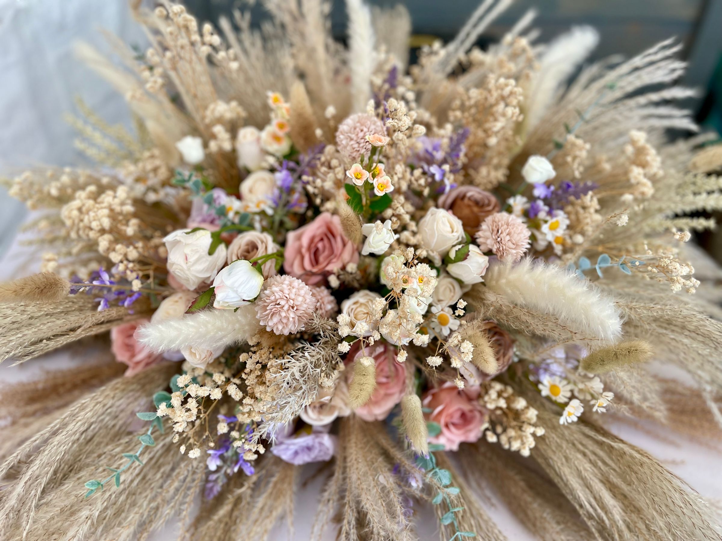Natural pampas plumes with artificial flowers and dries for a soft elegant finish