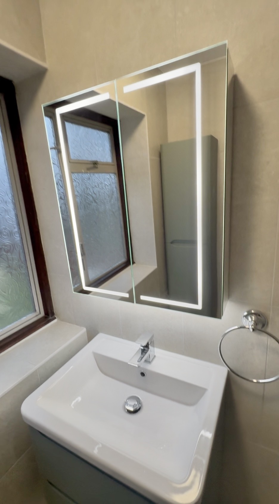 Modern mirror in new bathroom in New Malden 
